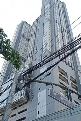 a street sign in front of a tall building at Lil Max Staycation in Manila
