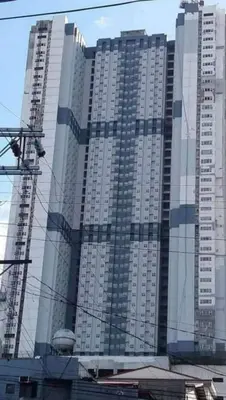 a large tall building with many windows at Lil Max Staycation in Manila
