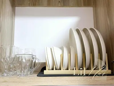a rack of plates and glasses on a table at Lil Max Staycation in Manila