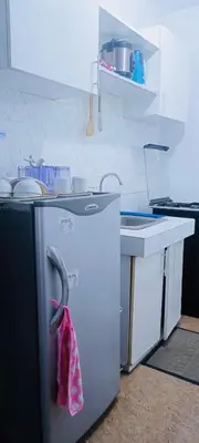 a kitchen with a refrigerator with a towel on it at Guest house avida condo in Manila