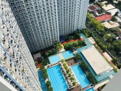 an aerial view of a large building with pools at Staycation sa Jazz by Amaya 3921 Tower B in Manila