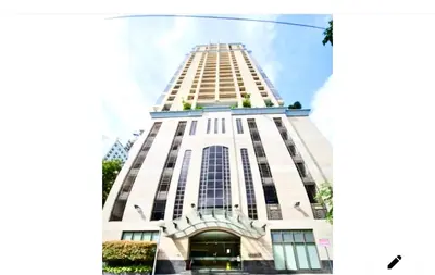 a tall white building with a lot of windows at Mosaic Tower in Manila