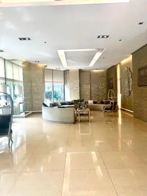 a lobby with a couch and a table at Mosaic Tower in Manila