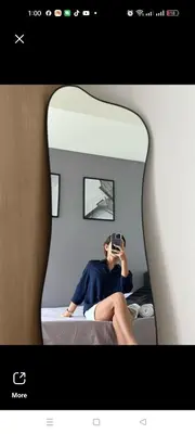 a woman taking a picture of herself in a mirror at Azure Staycation by Marco in Manila