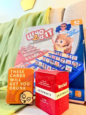 a pile of games and books on a couch at MOA Staycation at Shore 3 Residences Tower 1 in Manila