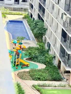 a playground in front of a building with a pool at MOA Staycation at Shore 3 Residences Tower 1 in Manila