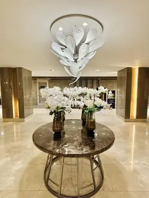a lobby with a table with vases of flowers on it at MOA Staycation at Shore 3 Residences Tower 1 in Manila