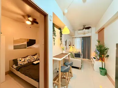 a bedroom with a bed and a desk in a room at MOA Staycation at Shore 3 Residences Tower 1 in Manila