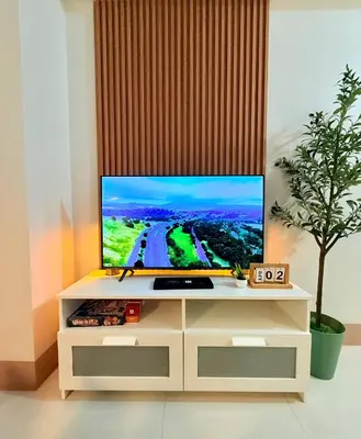 a television on a white entertainment center in a room at MOA Staycation at Shore 3 Residences Tower 1 in Manila