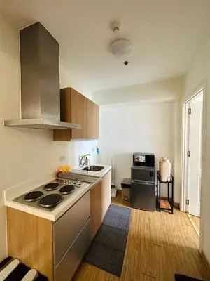 a kitchen with a stove and a sink in it at Azure staycation by marco in Manila