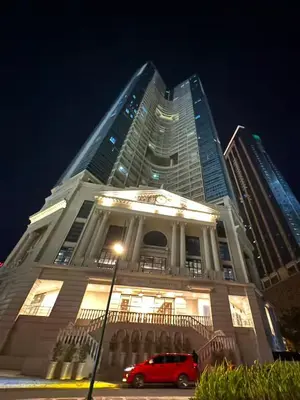 a building with a car parked in front of it at Uptown Parksuite 1 BR Tower 2 BGC Taguig in Manila