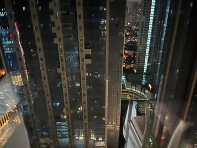 a view from the top of a skyscraper at night at Uptown Parksuite 1 BR Tower 2 BGC Taguig in Manila