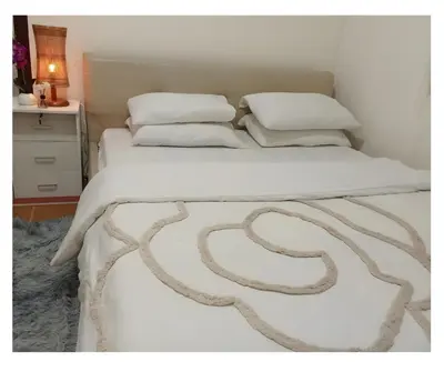 a bed with white sheets and pillows on it at 2BR PIONEER Woodland Boni,Mandaluyong connected to Boni MRT station in Manila