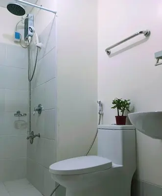 a bathroom with a shower and a toilet and a sink at 2BR PIONEER Woodland Boni,Mandaluyong connected to Boni MRT station in Manila