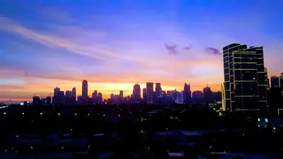 a view of a city skyline at sunset at Millionaire Makati Brio Tower in Manila