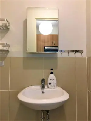 a white sink in a bathroom with a mirror at Millionaire Makati Brio Tower in Manila