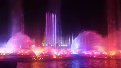 a water fountain in front of a building at night at Millionaire Makati Brio Tower in Manila