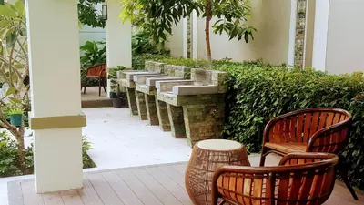 a patio with two chairs and a stone wall at Millionaire Makati Brio Tower in Manila