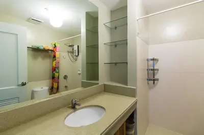 a bathroom with a sink and a mirror at Millionaire Manila Bay Sunset Penthouse views in Manila