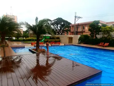 a person standing in front of a swimming pool at Millionaire Manila Bay Sunset Penthouse views in Manila