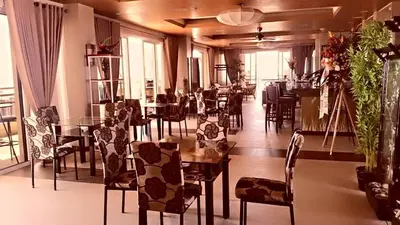 a restaurant with tables and chairs in a room at Millionaire Manila Bay Sunset Penthouse views in Manila