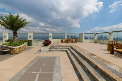 a patio with a view of the ocean on a building at Millionaire Manila Bay Sunset Penthouse views in Manila