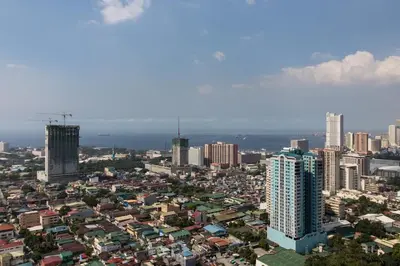 a city skyline with tall buildings in the foreground at Millionaire Manila Bay Sunset Penthouse views in Manila