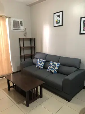 a living room with a couch and a coffee table at Millionaire Manila Bay Sunset Penthouse views in Manila