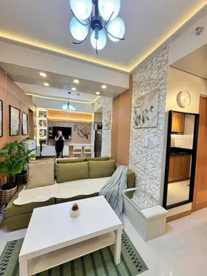 a living room with a couch and a table at MJM Cityscape at Red Residences in Manila