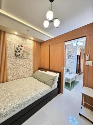 a bedroom with a bed with a wooden wall at MJM Cityscape at Red Residences in Manila