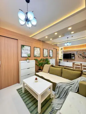 a living room with a couch and a table at MJM Cityscape at Red Residences in Manila