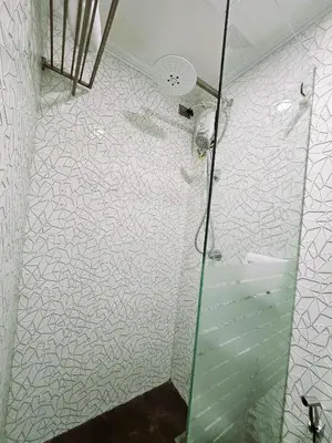 a bathroom with a shower with a glass door at Spacious & Cozy 1-Bedroom, Sleeps 2-4 in Manila