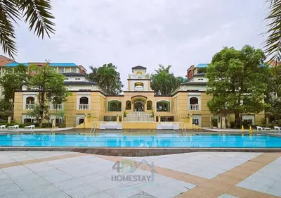 a large yellow building with a pool in front of it at Spacious & Cozy 1-Bedroom, Sleeps 2-4 in Manila