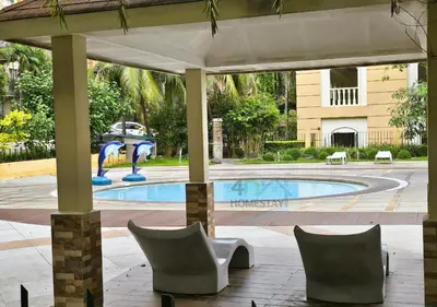 a pavilion with chairs and a swimming pool at Spacious & Cozy 1-Bedroom, Sleeps 2-4 in Manila