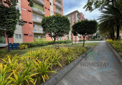 a walkway in a park with trees and buildings at Spacious & Cozy 1-Bedroom, Sleeps 2-4 in Manila