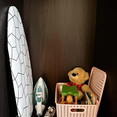a teddy bear sitting in a basket next to a surfboard at Crizzy's Hub Sariel at Shore Residences - 1BR with Netflix and Disney - Near MOA in Manila