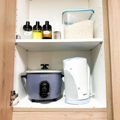 a coffee maker and a toaster on a shelf at Crizzy's Hub Sariel at Shore Residences - 1BR with Netflix and Disney - Near MOA in Manila