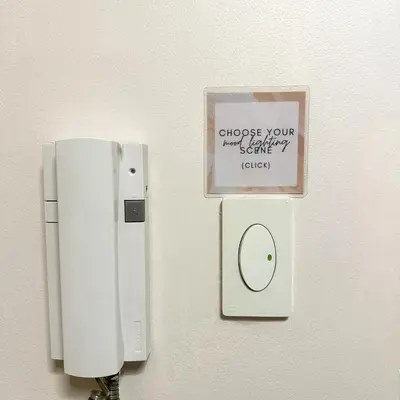 a phone on a wall with a sign on it at Crizzy's Hub Sariel at Shore Residences - 1BR with Netflix and Disney - Near MOA in Manila