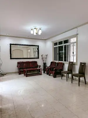 a living room with couches and a large mirror at 6-Bedroom Duplex with pool near NAIA in Manila