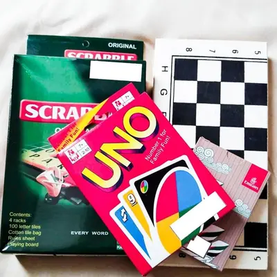 a pile of games and a box with a game at Crizzy's Hub Gabrielle at Shore Residences in Manila