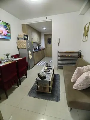 a living room with a couch and a table at Mall of Asia's Staycation in Manila