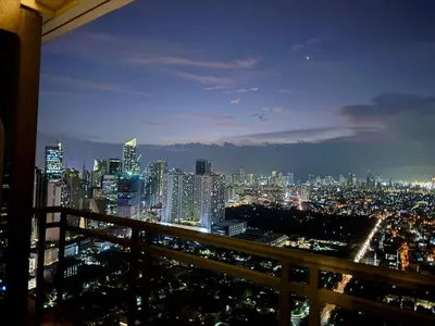 a view of a city skyline at night at Sky-High Studio with Netflix, Sunset View, and Disney in Manila
