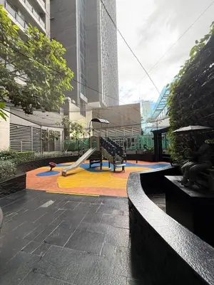 a playground with a slide in a city at Sky-High Studio with Netflix, Sunset View, and Disney in Manila