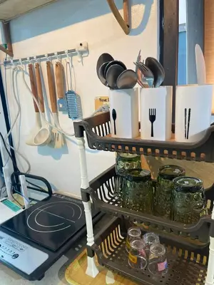 a shelf in a kitchen with utensils at Ortigas Condotel near Robinsons Galleria with free pool in Manila