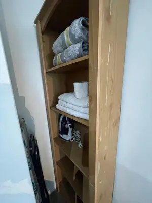a wooden shelf with towels and towels at Ortigas Condotel near Robinsons Galleria with free pool in Manila