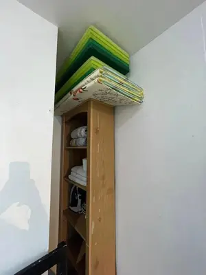 a book shelf in a room with somecellaneous items at Ortigas Condotel near Robinsons Galleria with free pool in Manila