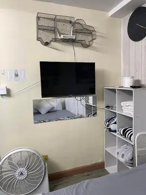 a room with a fan and a tv on a wall at ADB Avenue Tower GOOD FOR 5 PAX in Manila