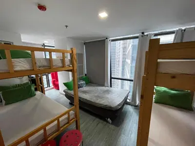 a dorm room with three bunk beds and a window at Modern Condotel in Ortigas good up to 8 pax in Manila