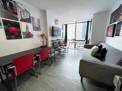 a living room with a couch and a table and chairs at Modern Condotel in Ortigas good up to 8 pax in Manila