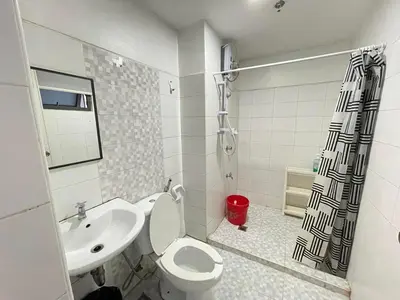 a bathroom with a toilet and a sink and a shower at Modern Condotel in Ortigas good up to 8 pax in Manila